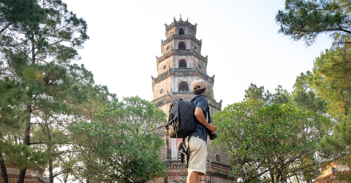 Valid Vietnam tourist visa in old passport - Faceless traveler near Pagoda Of The Celestial Lady