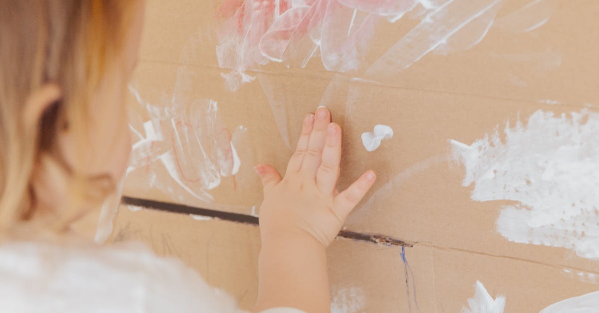 Vancouver YVR getting to quarantine with toddler - Crop anonymous child drawing with white paint at home