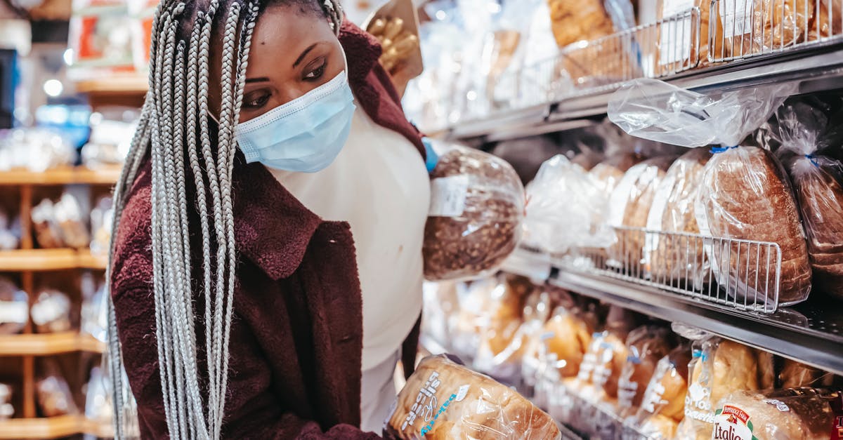 Various covid certificates for vaccinations done in Canada - Black woman choosing bread in baking department