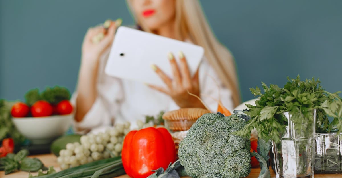 Vegetarian food in Morocco - Studio Shot of Vegetables on Table and Woman with Tablet in Background