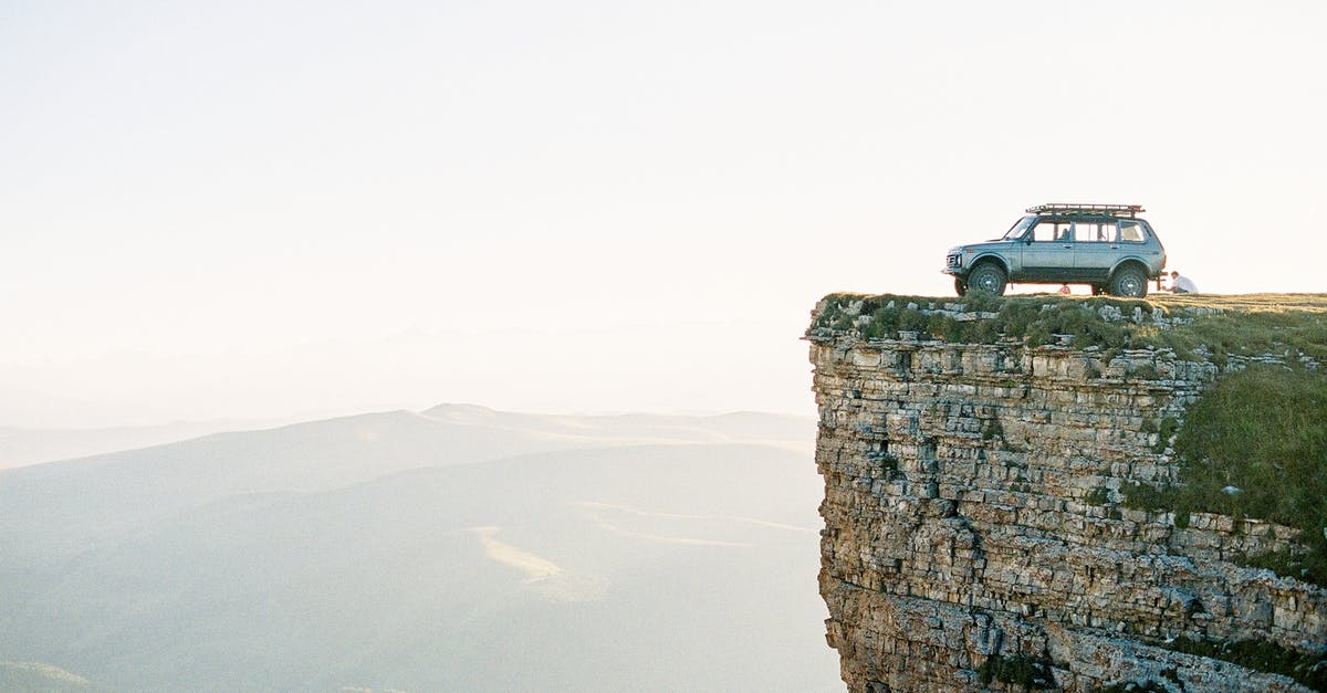 Vehicle insurance for Moldova - Black Car on Top of Brown Rock Formation