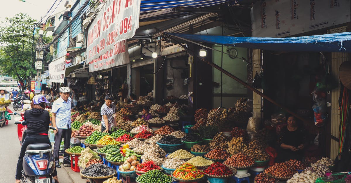 Vietnamese customs/paperwork - Person in Scooter in Front of Vegetables