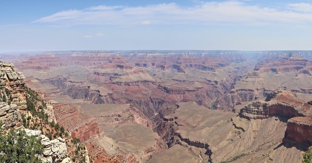 View the Grand Canyon by helicopter - is it real? - Grand Canyon Under Blue and White Cloudy Sky