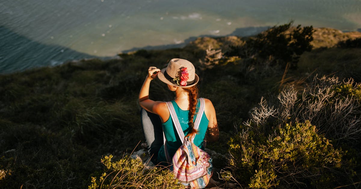 Viewing, not hiking, Mount Kilimanjaro from Arusha - Faceless female tourist with rucksack enjoying lake from mount