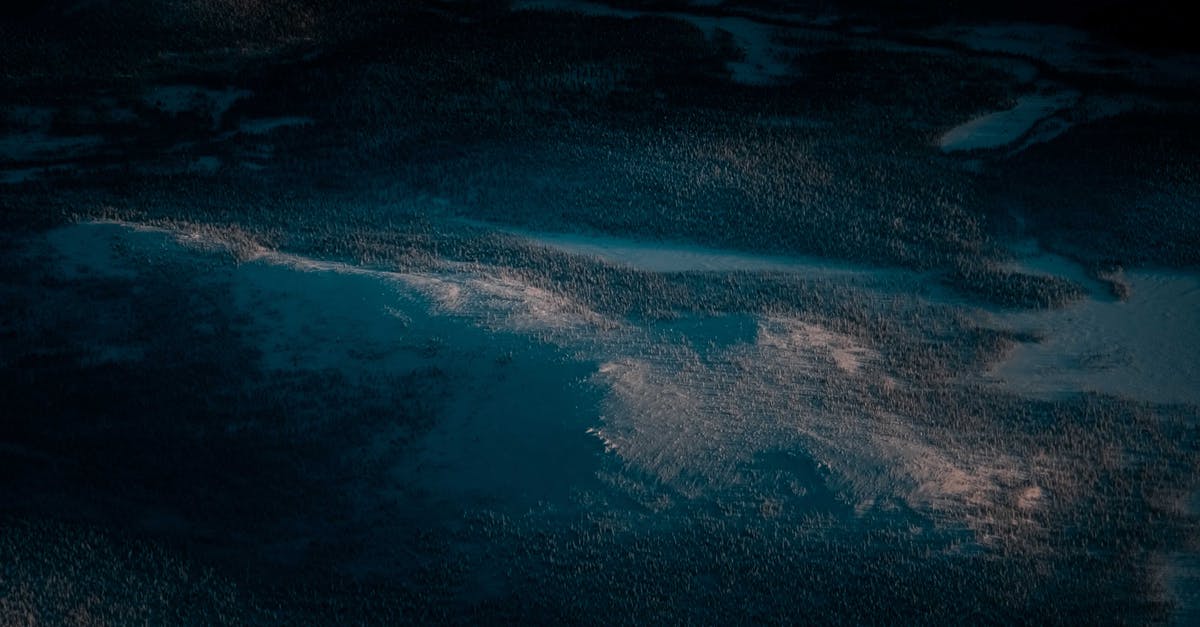 Viewing, not hiking, Mount Kilimanjaro from Arusha - Picturesque aerial view of mountain ridge covered with snow and lush woods in winter evening