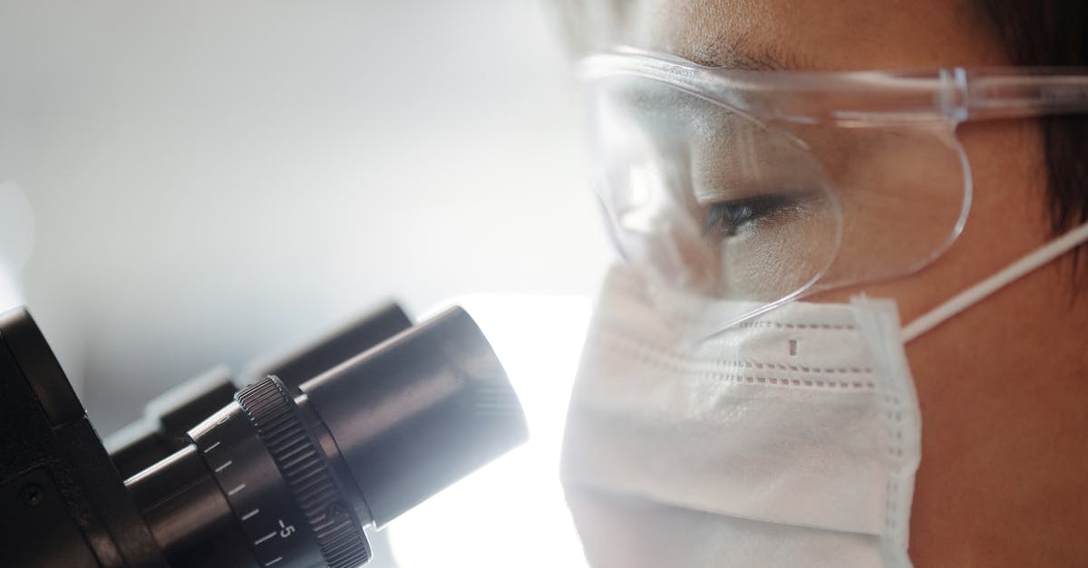 Virgin Atlantic - Approved COVID-19 Test Centres - Man Looking Through A Microscope