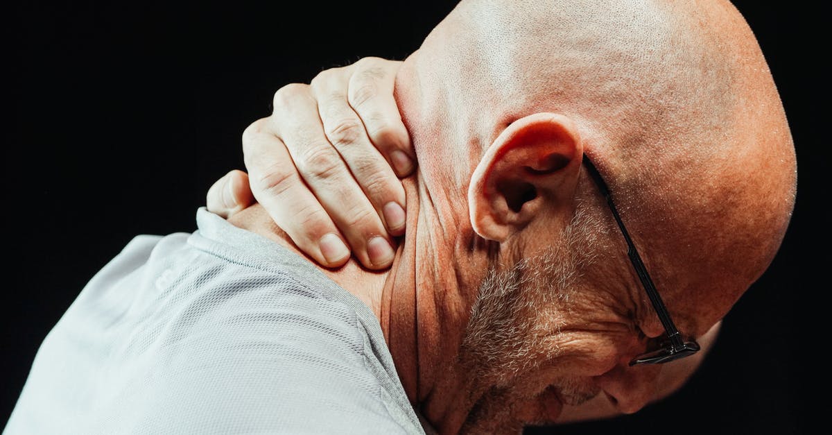 Visa extension after injury - Close-Up Photo of a Man Having a Neck Pain