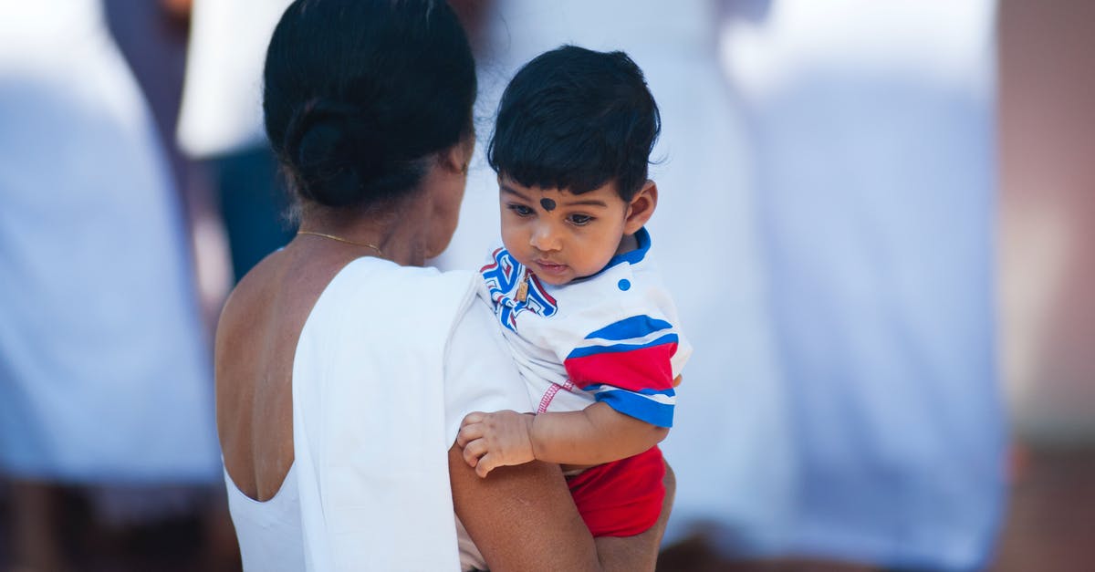 Visa extension in India for a baby U.S citizen - Selective Focus Photography of Woman Holding Child