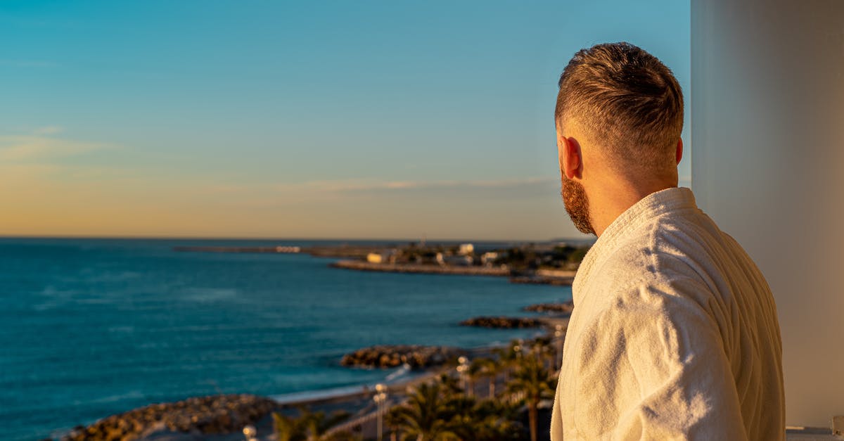 Visa for France - showing actual hotel booking? - Man Wearing Bathrobe While Looking Out in the Scenery