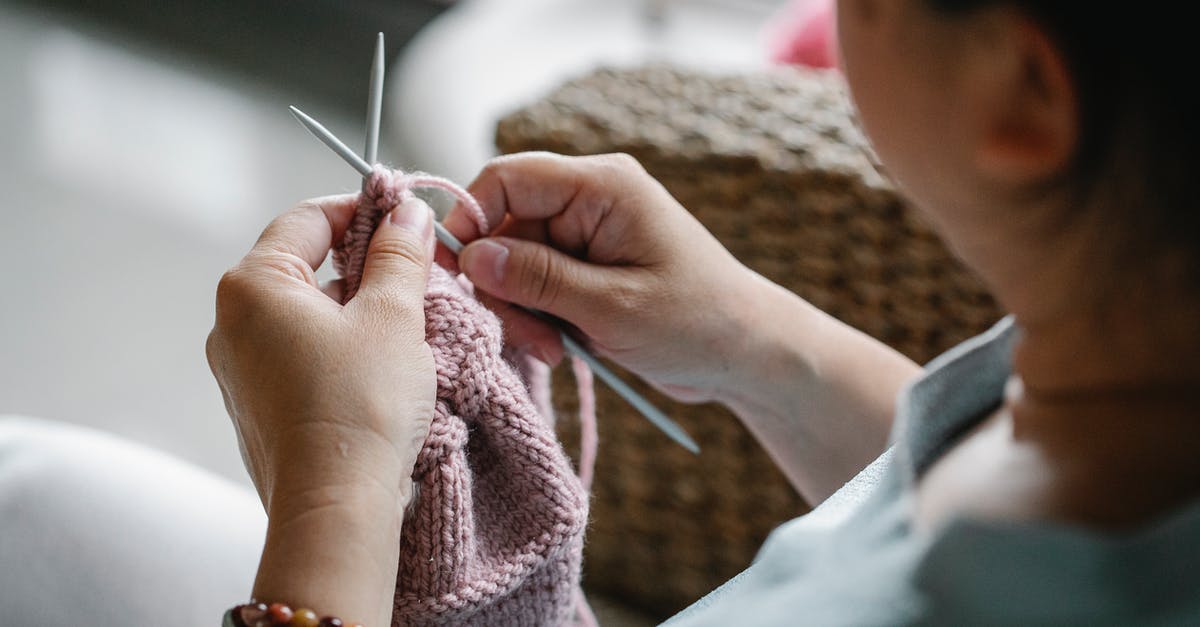 Visa refused in Admin Process but passports are in hold - Crop faceless female holding needles and knitting pink cloth while sitting at home