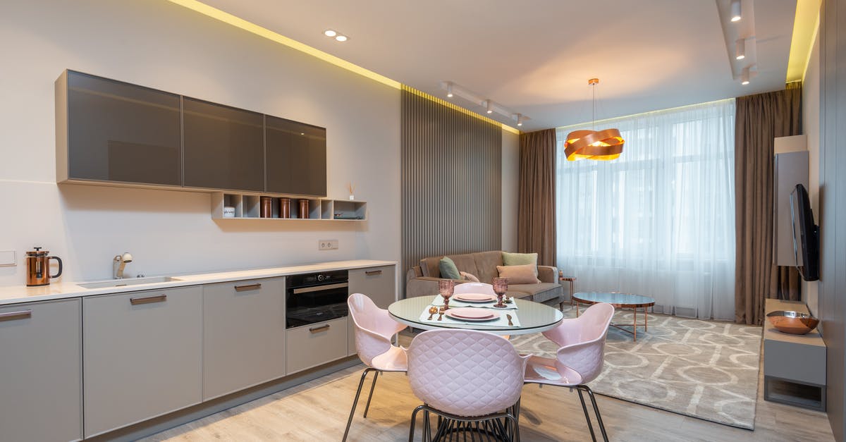 Visa requirements for Macedonia for Schengen-zone Permanent Residents? - Modern living room with cozy sofa near stylish kitchen zone and round glass dining table