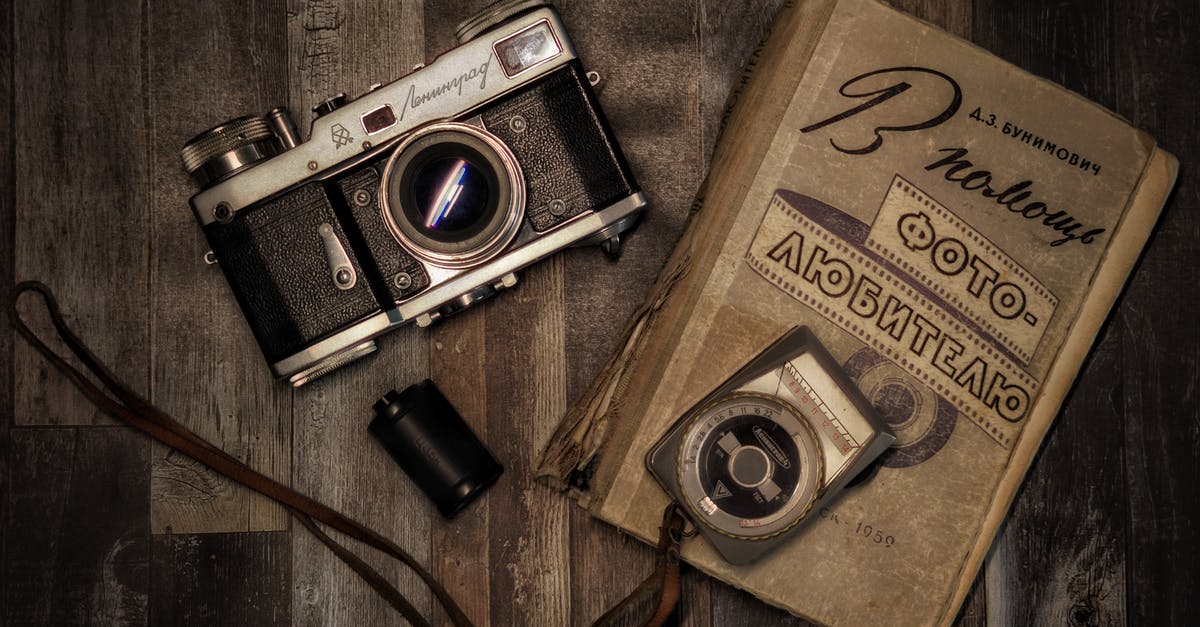 Visa stamp damaged in torn passport? - Vintage Camera and a Book on Wooden Surface