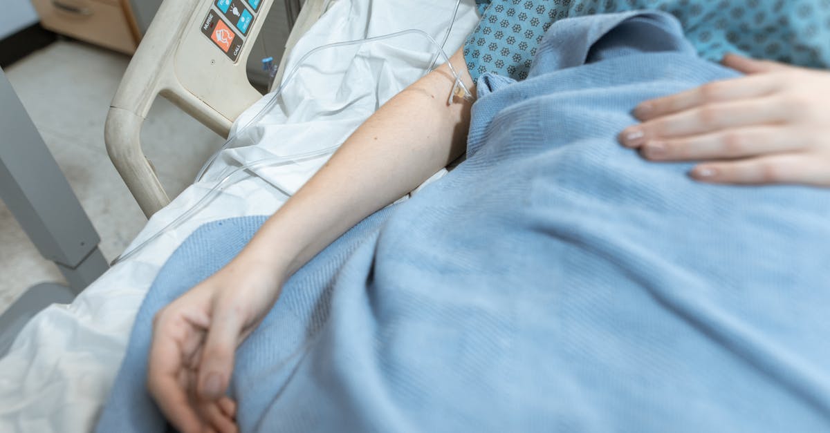 Visiting doctors while staying in Australia? - Person in White Shirt Lying on Hospital Bed