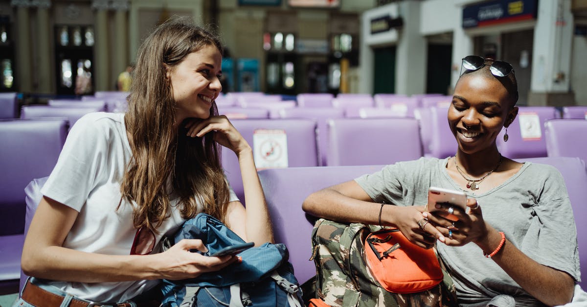 Visiting friends while in transit - Women Travelers Visiting City with Backpacks