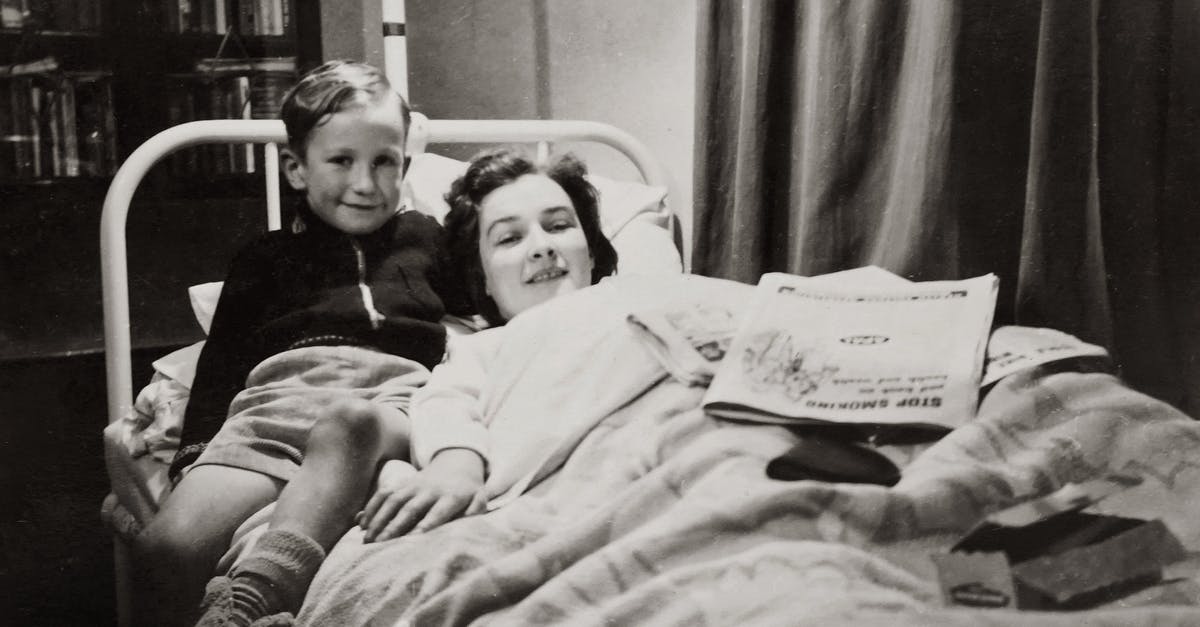 visiting mom from Romania to Canada - Grayscale Photo of A Boy Sitting Beside His Mother Lying On A Hospital Bed