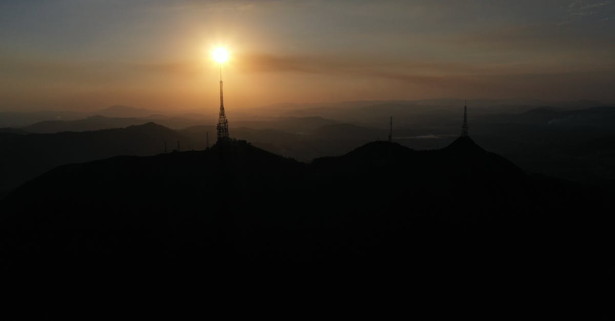 Visiting the Eiffel Tower -- going early to avoid queue - Sunrise over hilly terrain with telecommunication towers