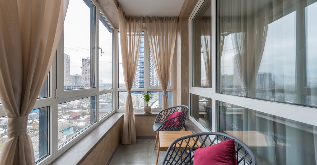 Visiting the housing projects in New York City? - Chairs and coffee table placed in patio of contemporary apartment