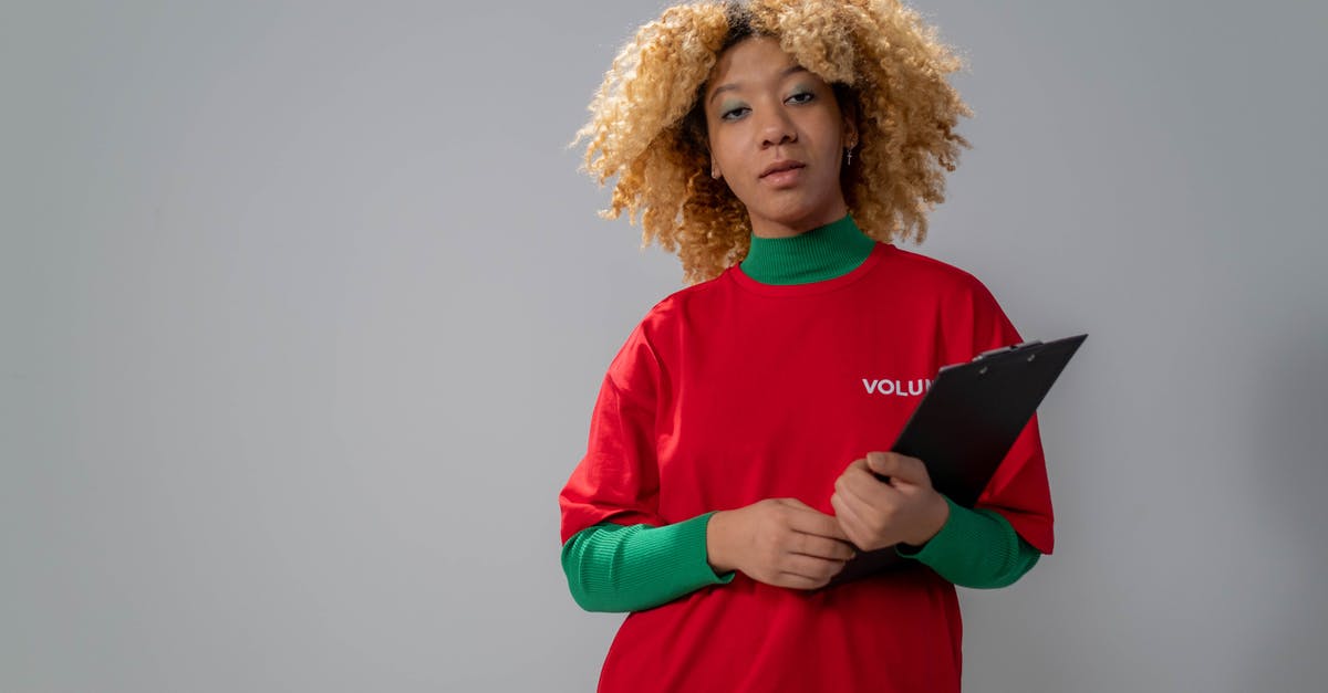 Volunteering for an archaeological dig - Woman in Red Long Sleeve Shirt Holding Black Book