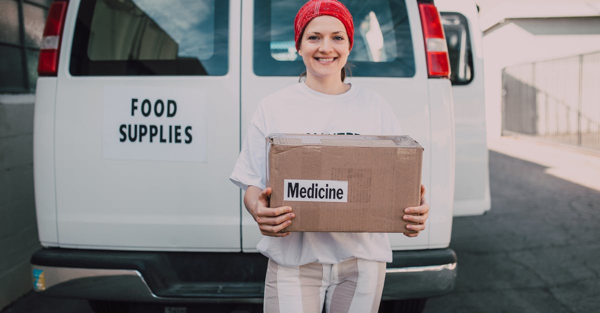 Volunteering opportunities when travelling overseas - Woman Carrying a Medicine Labelled Cardboard Boxes Behind a White Van