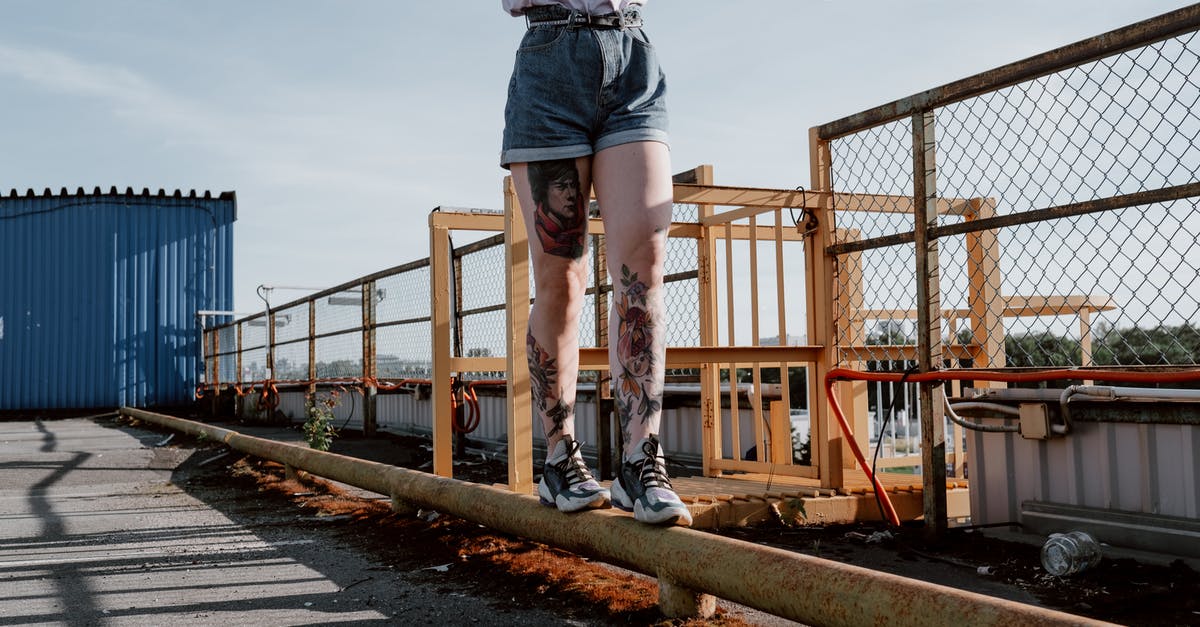 Walking across Australia? - Man in Grey Shirt and Blue Denim Shorts Standing on Brown Wooden Bridge