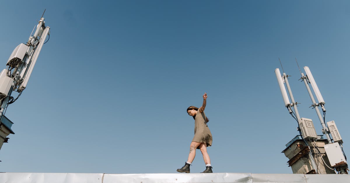 Walking from Santiago to Buenos Aires - Man in Brown Shorts Jumping on White Concrete Building