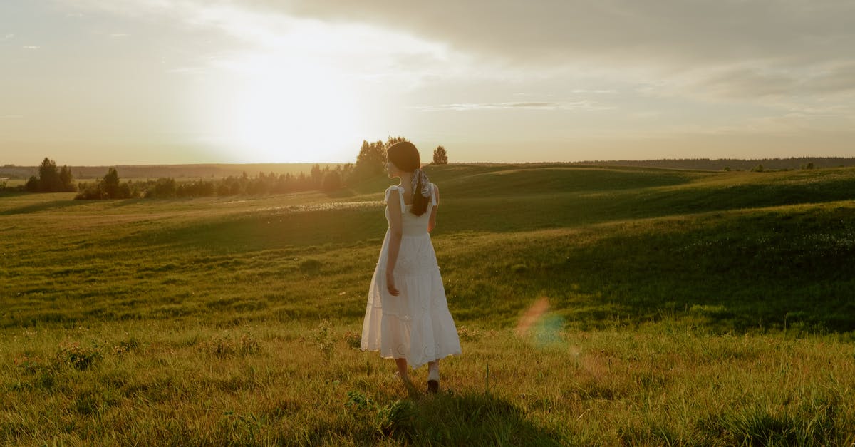 Walking from Santiago to Buenos Aires - Woman in White Dress Walking Through Meadow