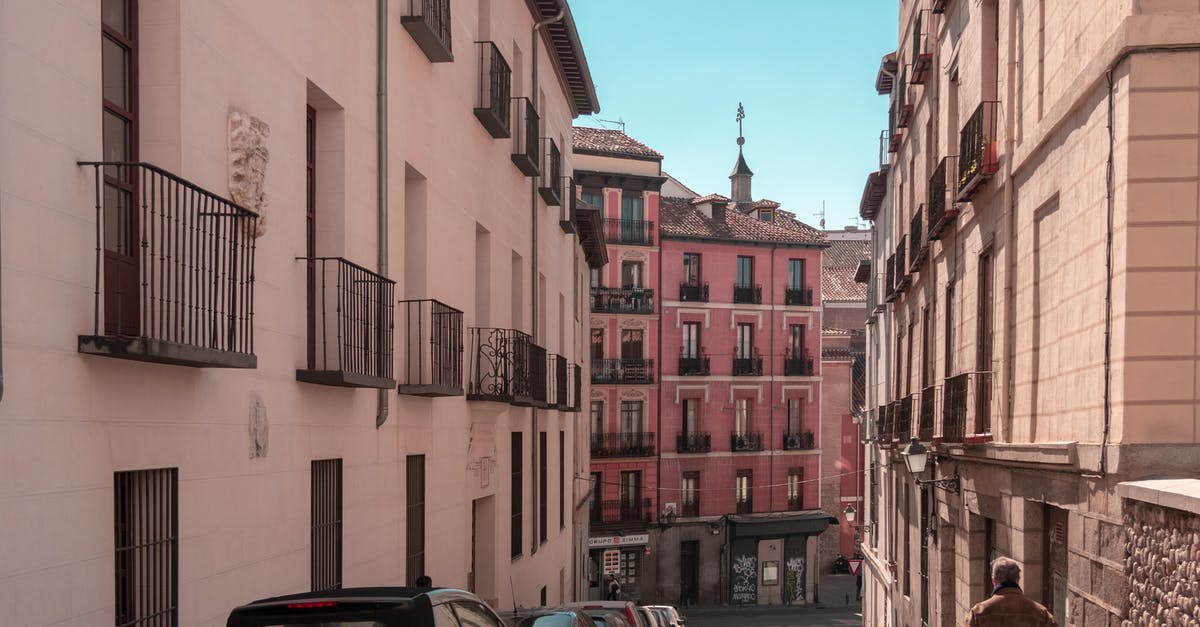 Walking on a road in Spain - Vehicles Parked Beside Buildings