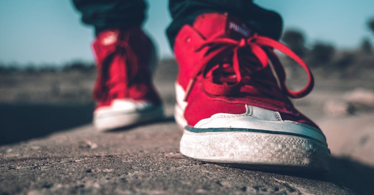 Waterproof shoes or (more comfortable) trainers for walking a lot in Paris in October? [closed] - Photo of Person Wearing Red Shoes