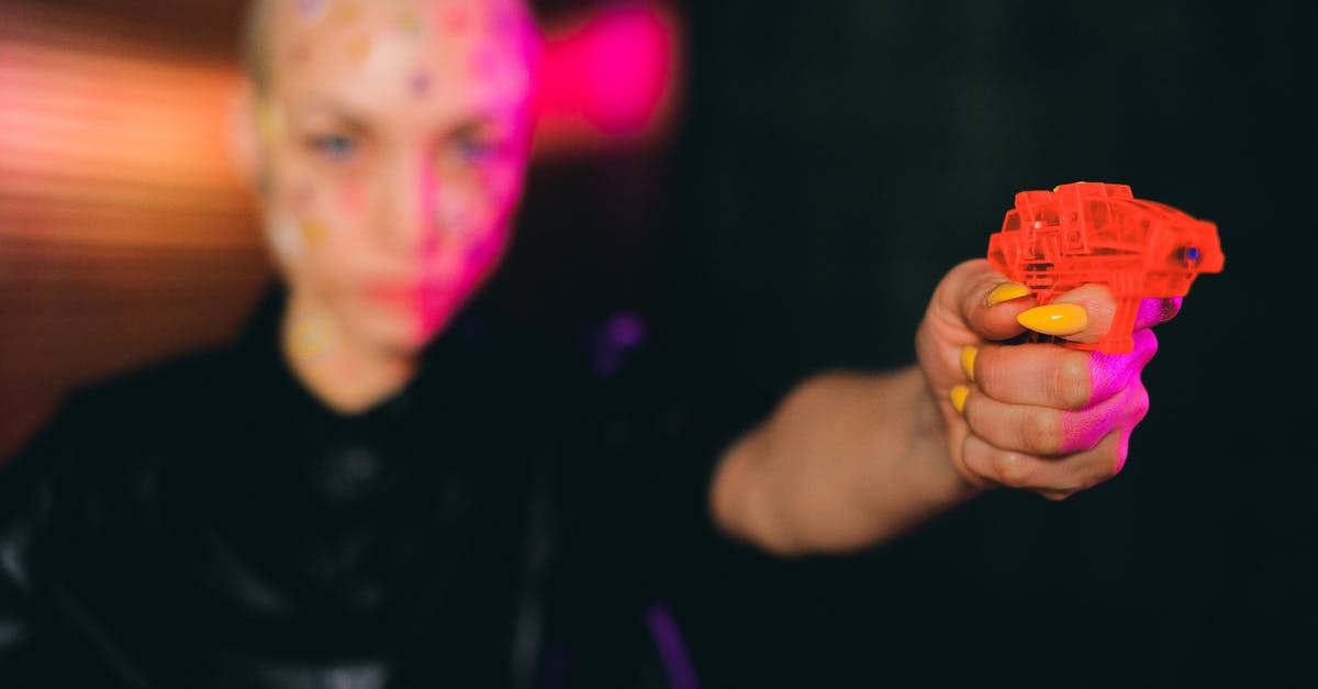Weird points calculation at Qantas Frequent Flyer - Eccentric bald woman pointing toy gun in dark studio
