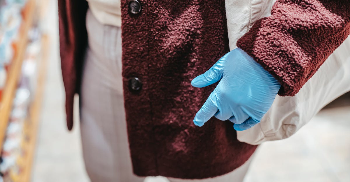 What's a good alternative to Dopplr? - High angle of crop unrecognizable female client in latex gloves with zero waste shopping bag selecting food in grocery store