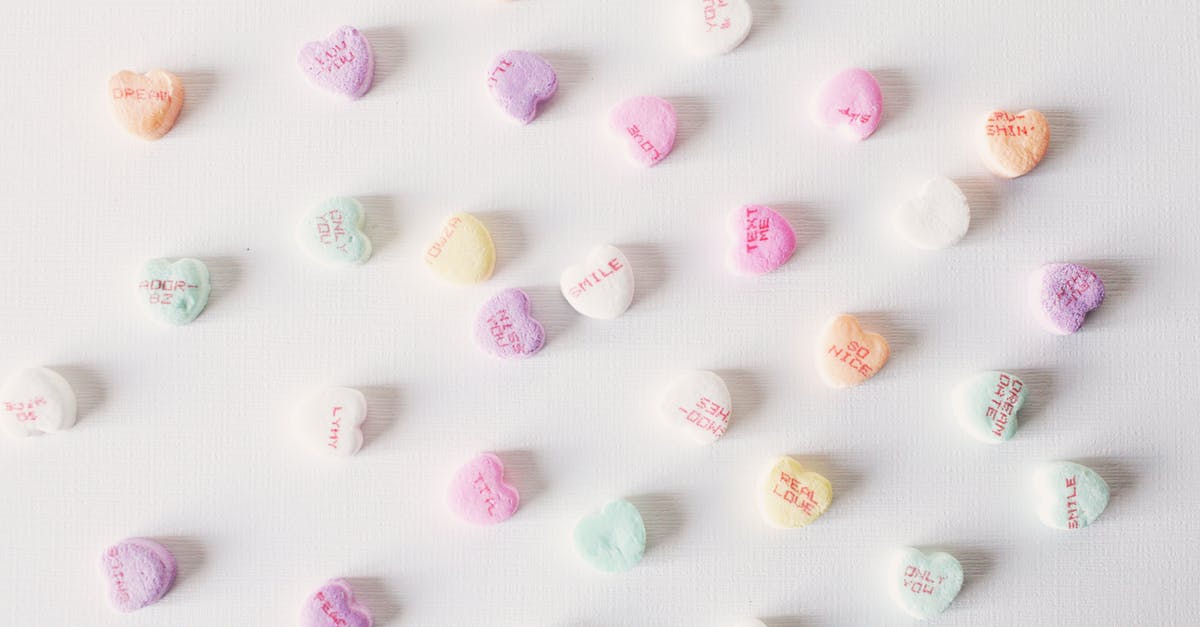 What's that weird food called that they eat in Dover Delaware? - Top view composition of multicolored small heart shaped sweets placed on plain white surface