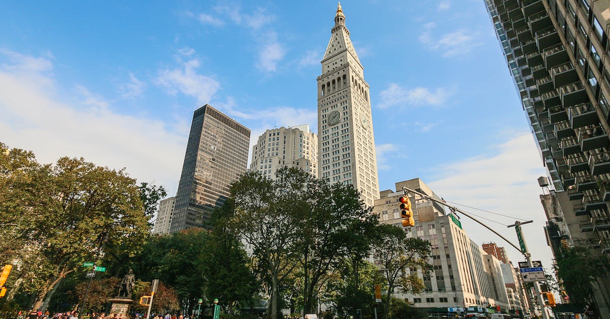 What's the best time to get "last-minute" discount hotel prices? - People Walking on Street Near High Rise Buildings