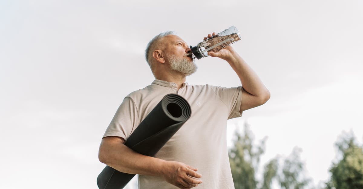 What's the drinking age in Barbados? - An Elderly Man Sipping Water from Tumbler