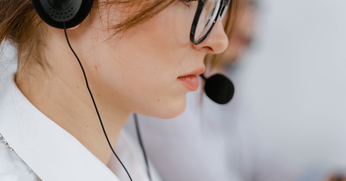 What's the most cost-effective service for calling landlines while travelling? - Woman Wearing Eyeglasses with Black Headset and Mouthpiece