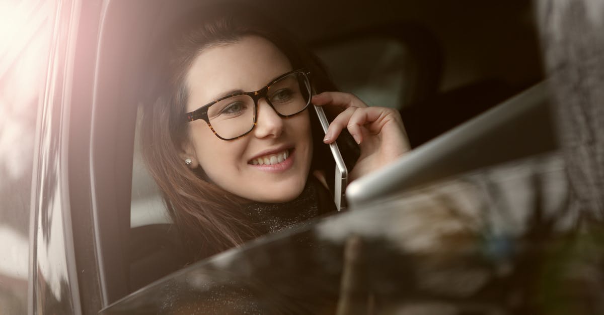 What's the most cost-effective service for calling landlines while travelling? - Sideview Photo of a Woman Using Mobile Phone