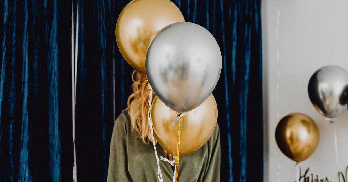 What's this celebration in Japan? - Woman in Black Jacket Holding White and Blue Balloons