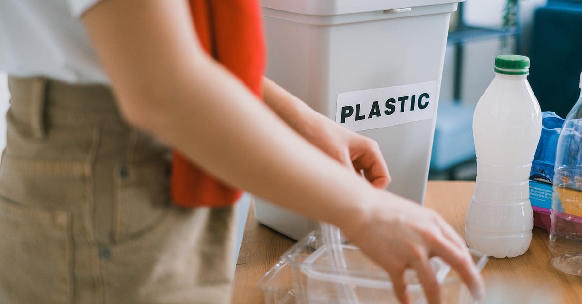 What are 'speed codes' used to compose UK immigration refusal notices? - Crop anonymous female in casual clothes standing near bucket for plastic and sorting out rubbish in light room