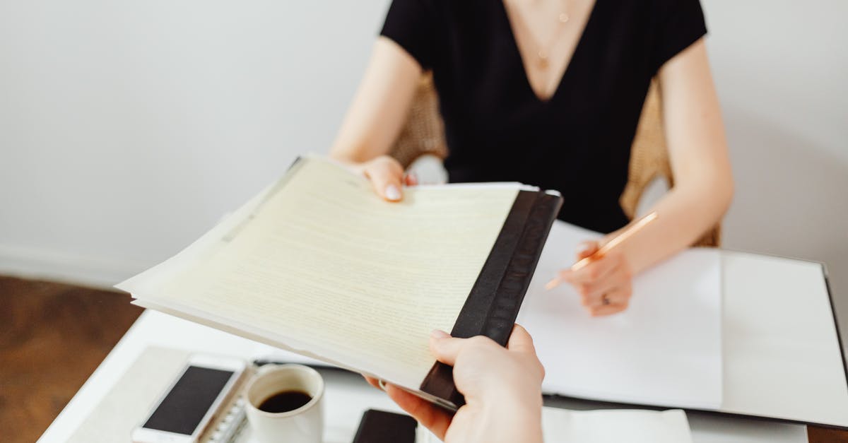 What are my chances of getting the B2 visa? [closed] - Close-Up Photo of a Person Holding Documents