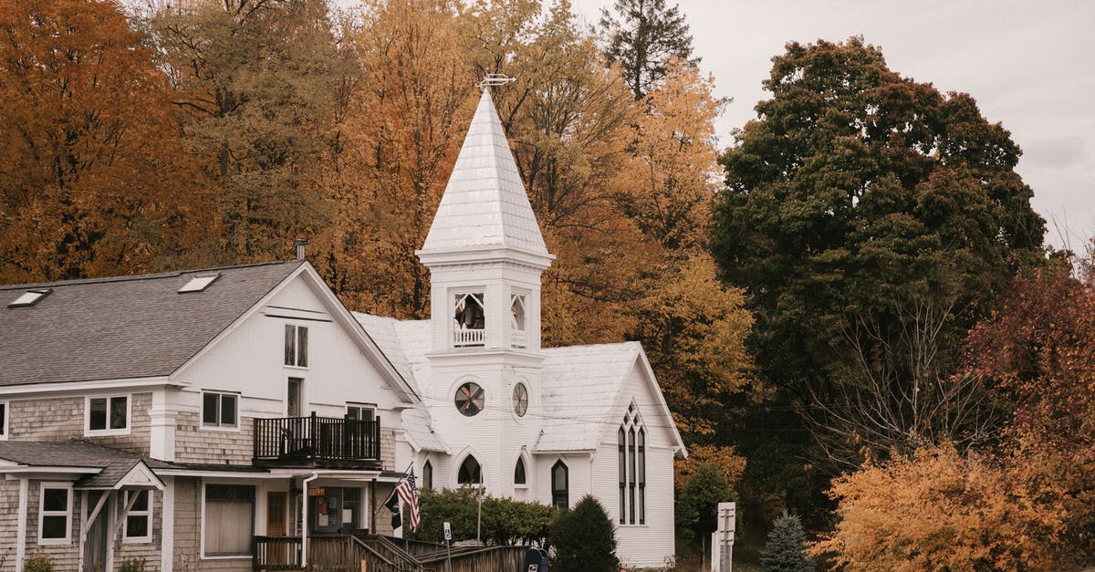 What are Samoan roadside stands selling in white styrofoam cups? - Facade of contemporary white house on roadside surrounded with yellow trees on autumn day