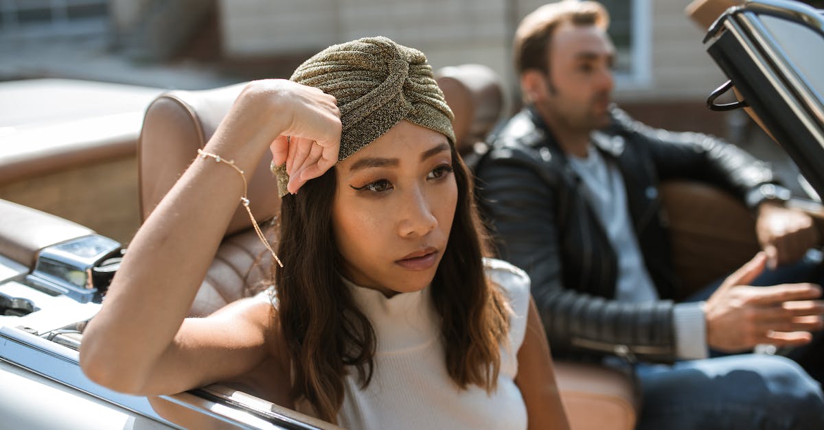 What are some techniques to avoid annoying the travel mate? - Woman in White Tank Top Sitting In A Car Feeling Annoyed