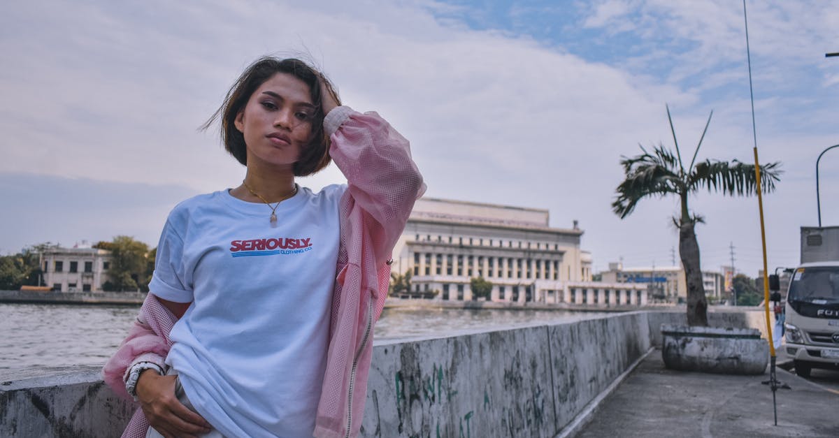 What are the buildings in this photo of Atlanta? - Woman in Pink Jacket Standing Near Body of Water