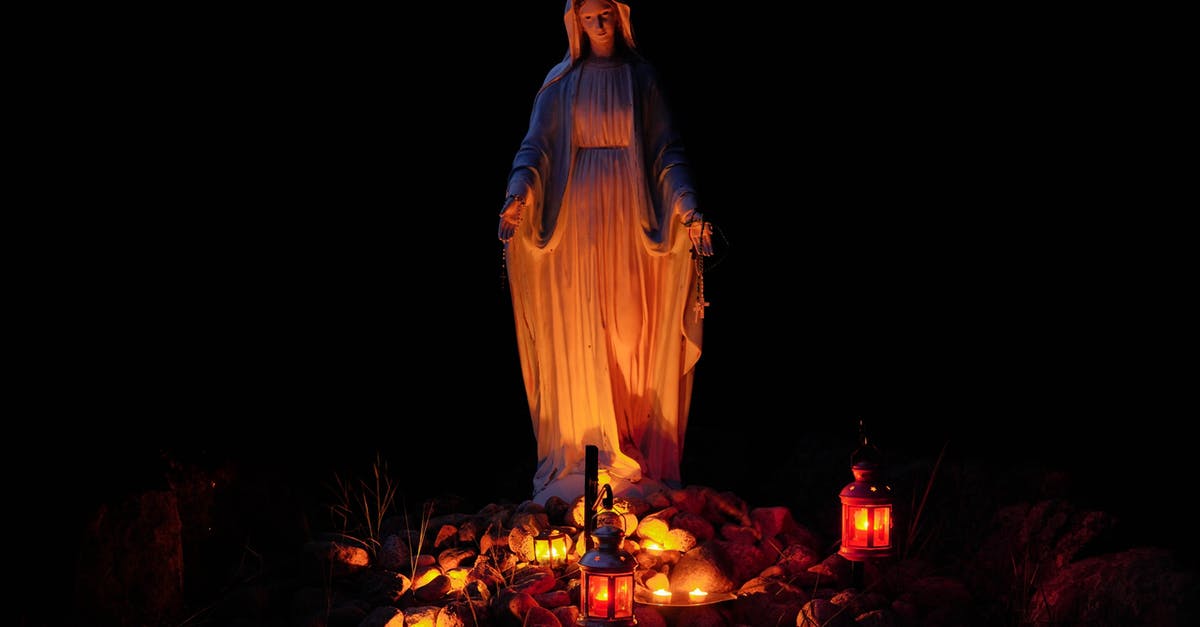 What are the candles outside in Denmark about? - Statue of a Virgin Mary Lighted by Candles