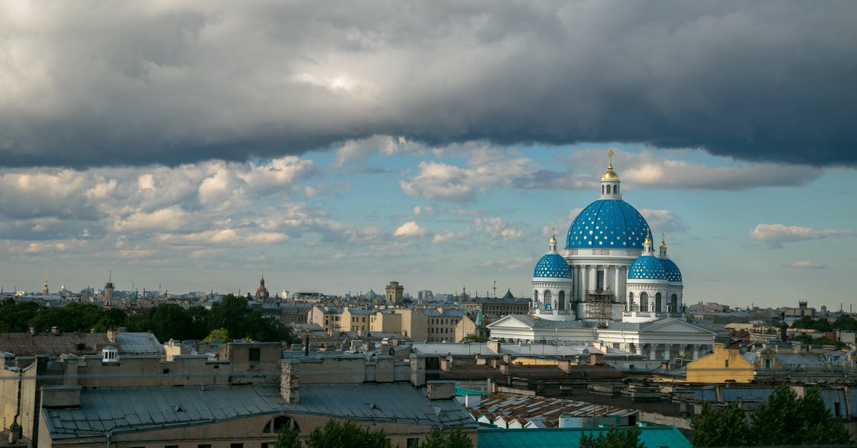 What are the cheapest trains from Helsinki to Saint Petersburg? - From above of Saint Petersburg cityscape with many buildings and famous Trinity cathedral under cloudy blue sky