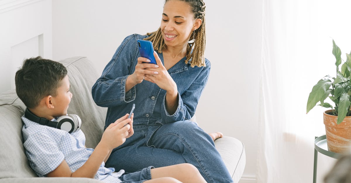 What are the drawbacks of taking TWO (unconnected) indirect flights? - Woman in Blue Denim Jumpsuit Taking Photo of Boy