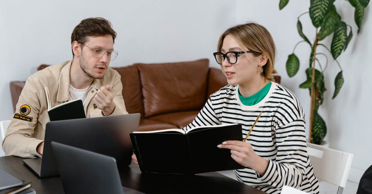 What are the limits when carrying laptops and electronics to USA? - Man and Woman Discussing in Workplace