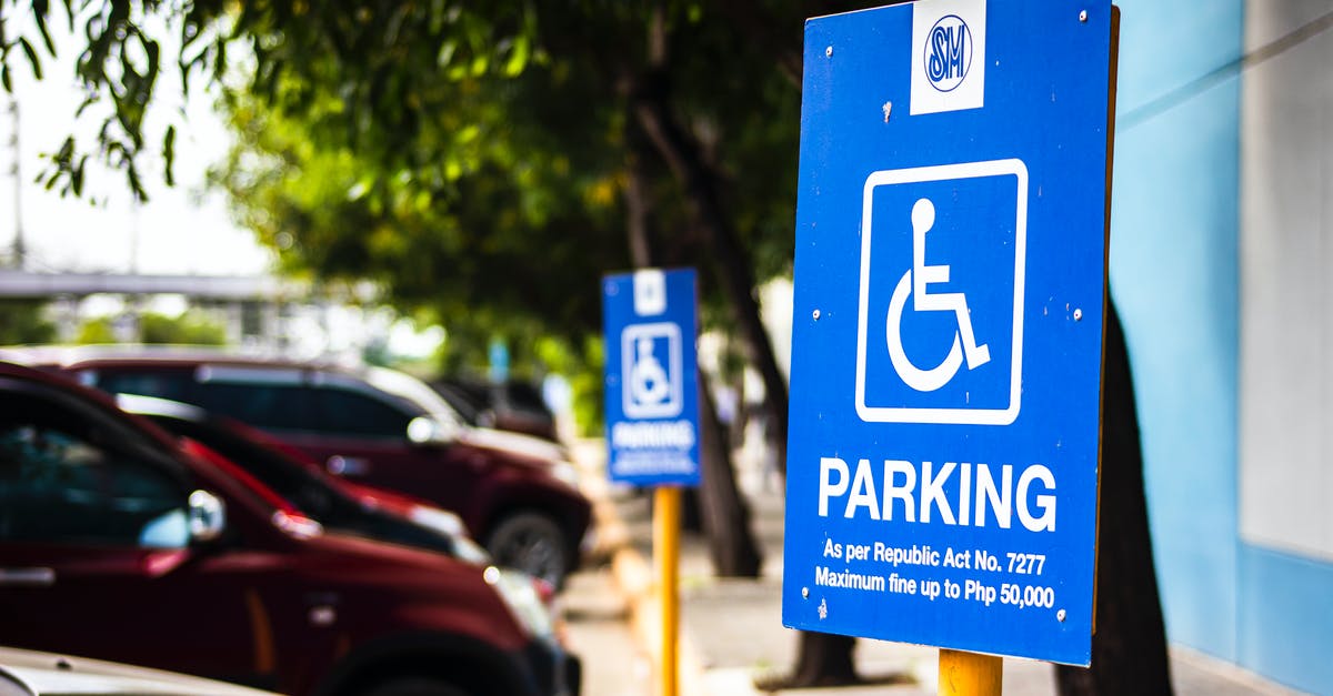 What are the parking regulations in Brooklyn? - Signboard representing rule for disabled people parking only near vehicles and sidewalk in city