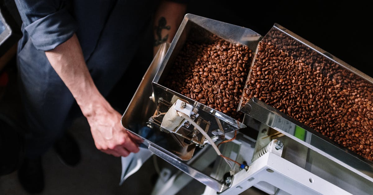 What are the places that sell coffee beans called in Turkey? - Person Holding Brown and Silver Food Tray