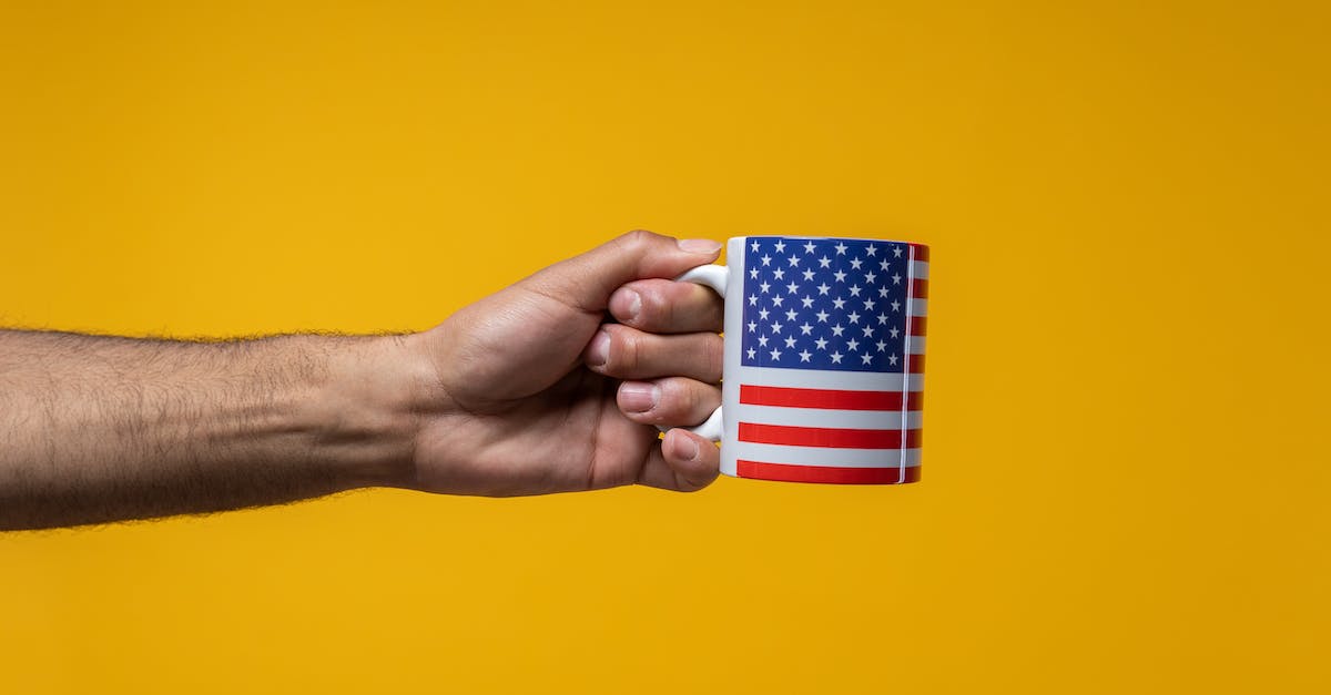 What are the prices of coffee in Poland compared to USA - Person Holding a Mug with a US Flag Design