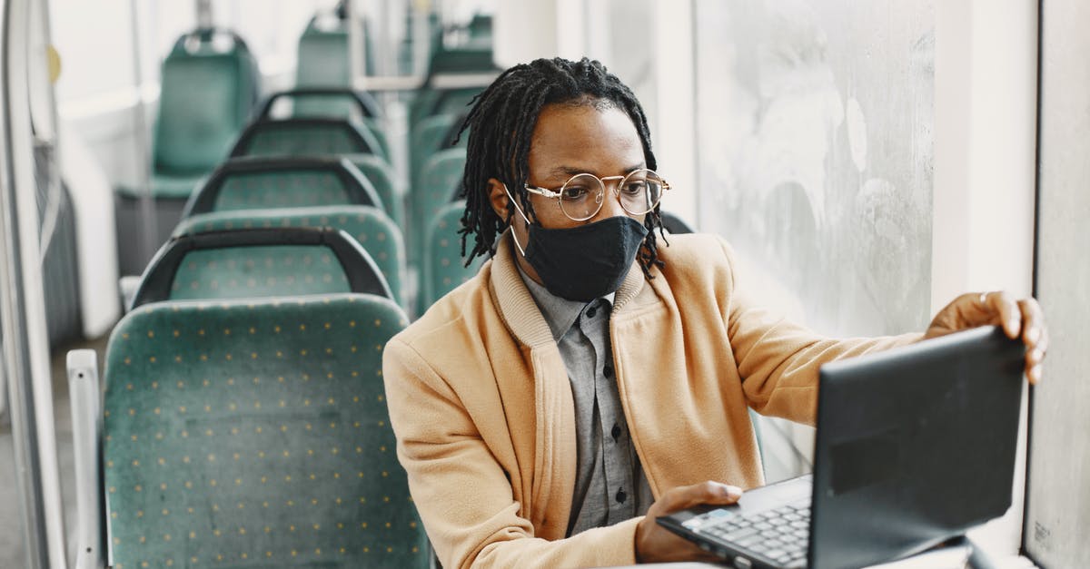 What are the safest bus companies in Bolivia and Chile? - Young Man in a Bus Wearing a Face Mask and Using Laptop 