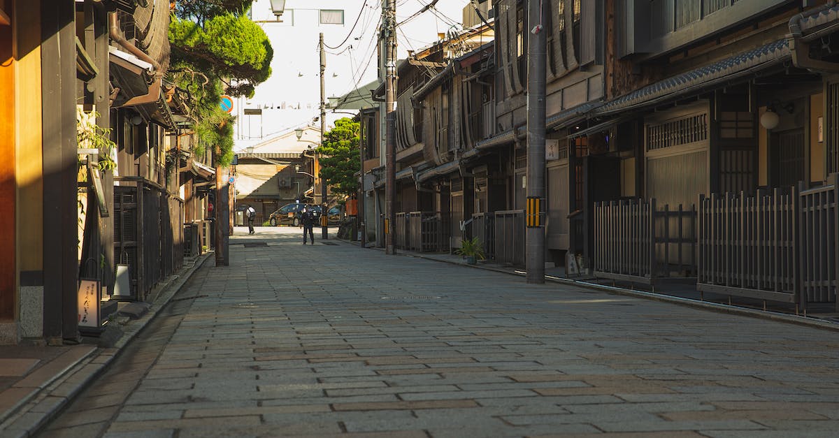 What are the typical meals in Japan? - Empty paved street in historic district of Kyoto with aged residential houses on sunny day